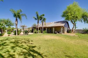 a house with palm trees and a yard at Luxe Scottsdale Home with Horse Stables and Pool! in Scottsdale