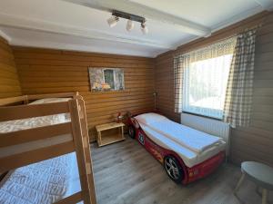 a bedroom with a bed with a car on it at Haus 44 Feldblick Fewo 1 oben in Arrach