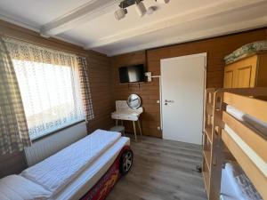 a small room with a bed and a window at Haus 44 Feldblick Fewo 1 oben in Arrach