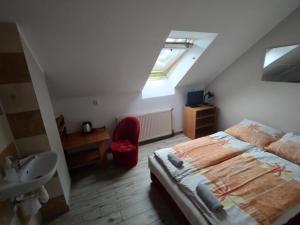 a bedroom with a bed and a sink and a window at Willa Solna in Kołobrzeg