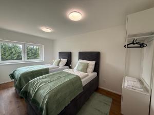 two beds sitting next to each other in a bedroom at Vily Pod Vyhlídkou in Velké Losiny