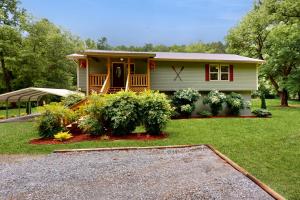 a small house with a driveway in front of it at Canoe House in Ellijay