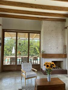 a living room with a chair and a fireplace at Casa de Campo con Piscina, BBQ y Naturaleza Cañete in Imperial