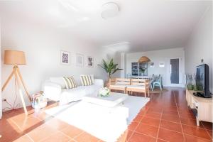 a living room with a white couch and a table at T3 Moledo Com Piscina e Vista Mar in Moledo