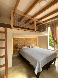 a bedroom with a bunk bed and a ladder at Casa de Campo con Piscina, BBQ y Naturaleza Cañete in Imperial