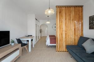 a living room with a couch and a table at Parque Carolina 208 in Costa Del Silencio