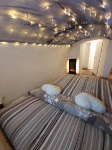 a bedroom with a bed with pillows and lights at Anno Wohlfühlidylle in Kirchdorf im Wald