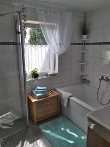 a bathroom with a tub and a sink and a window at Anno Wohlfühlidylle in Kirchdorf im Wald +15 photos