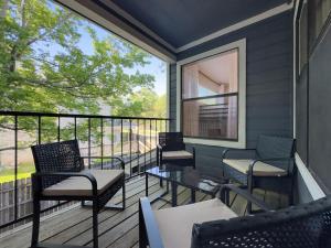 a balcony with chairs and tables and a large window at Lux Private Retreat - King Bed in Austin