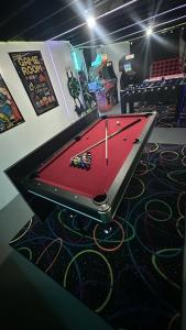 a ping pong table in a room with a pool game at Sleeps 18 6BR Gym, Game Room and Theater in Chicago