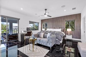 a bedroom with a bed and a couch at Waterfront Luxe Pool, Hot Tub, Theater, Games and more in Key Largo +85 photos