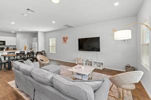 a living room with a couch and a dining room at Luxury Spacious GameRoom Sleeps 15 people in Austin