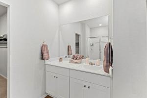 a white bathroom with a sink and a mirror at Luxury Spacious GameRoom Sleeps 15 people in Austin +58 photos
