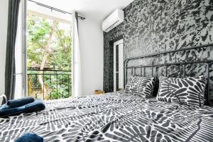 a bedroom with a zebra print bed with a window at 2 Private Suits - Art, Location, Quiet, Balconies in Sofia