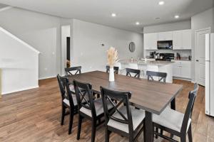 a kitchen and dining room with a wooden table and chairs at Luxury Spacious GameRoom Sleeps 15 people in Austin