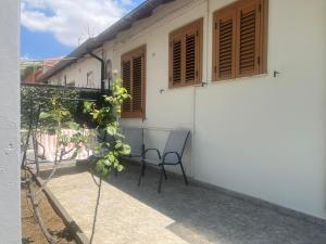 a chair sitting on the side of a house at House Federica in Melfi