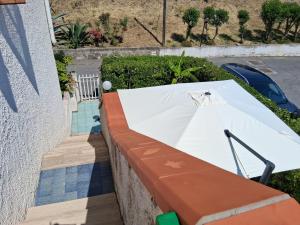 a white table on a wall next to a pool at Casa sul mare vicino Diamante in Belvedere Marittimo +17 photos