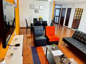 a living room with a couch and chairs and a table at Cálido Dpto. en Bustamante in Arequipa
