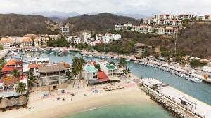 an aerial view of a beach and a harbor at La Playa Suites in Santa Cruz Huatulco