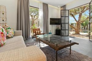 a living room with a couch and a glass table at Dariana guest house - adult only in Marrakech