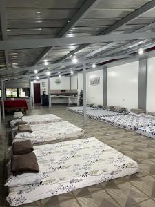 a row of mattresses lined up in a room at Casa de Descanso in Kiawagan