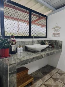 a bathroom with a sink on a counter with a window at Casa de Descanso in Kiawagan +15 photos