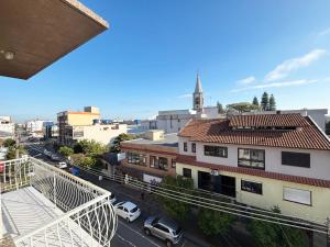 a view of a city street with cars on the road at Pousada Dona Luiza in Carlos Barbosa