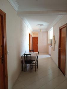 a dining room with a table and chairs at Appartement à usage familial in Agadir
