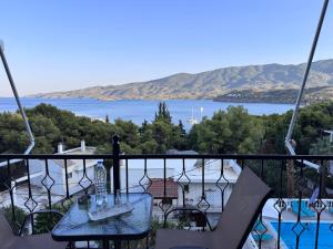 a balcony with a view of a body of water at Mina Apartments in Poros