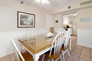 a dining room with a table and chairs at Beach Club #118 in Saint Simons Island