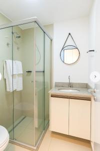 a bathroom with a glass shower and a sink at Otima localizacao metro Sacoma Aeroporto Congonhas Av Paulista Great location 80m subway near Av Paulista and Congonhas Airport Smart TV 50 free channels 600gb WiFi Pool Gym in Sao Paulo