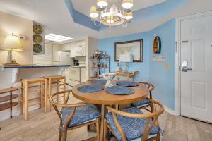 a kitchen and dining room with a table and chairs at Beach Club #127 in Saint Simons Island