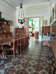 a dining room with a wooden table and chairs at Casa rosa 2 in Mercedes