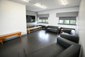 a living room with couches and a projection screen at Cunninghame 4 in Beith