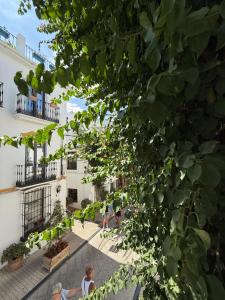 people walking in the courtyard of a building at La Clé Boutique Hotel Old Town Marbella in Marbella