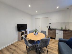 a living room with a table and chairs and a kitchen at Sarah in Aix-les-Bains