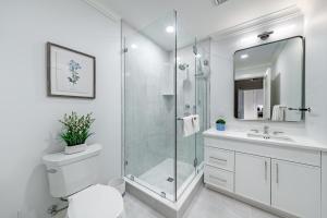 a bathroom with a shower and a toilet and a sink at Q Club Suite - Saratoga Adelphi Hotel in Saratoga Springs +6 photos