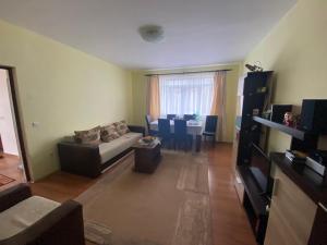 a living room with a couch and a table at Vila Costea in Geoagiu Băi