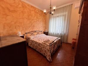a bedroom with a bed and a chandelier at Podere Campanella in Sinalunga