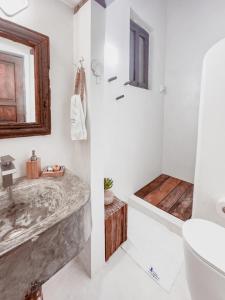 a bathroom with a marble sink and a tub at Posada La Gotera in El Roque +13 photos