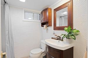 a bathroom with a sink and a toilet and a mirror at 15m to NY Cozy Relaxing Home in Hackensack +20 photos