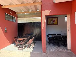 a patio with a table and chairs in a building at Pousada Caminhos do Interior in Sorocaba +4 photos