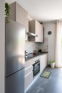 a kitchen with a stainless steel refrigerator in a room at Mirti Suite Roma in Rome