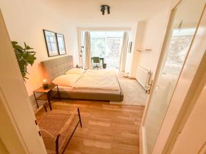 a bedroom with a bed and a table and a window at Danube Holiday Rooms in Krems an der Donau
