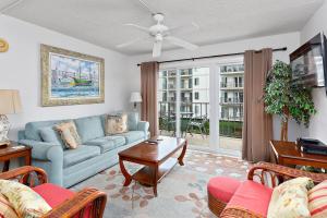a living room with a couch and a table at Beach Club #224 in Saint Simons Island