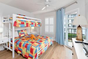 a bedroom with a bunk bed and a desk at Beach Club #224 in Saint Simons Island +30 photos