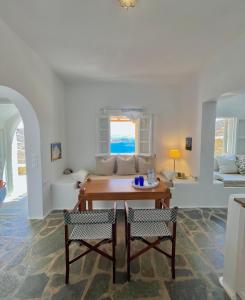 a living room with a table and a couch at Akra in Houlakia