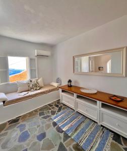 a living room with a bench and a window at Akra in Houlakia