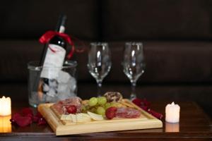 a table with a plate of food and two wine glasses at HOTEL PLAZA SAN CRISTOBAL INN in San Cristóbal de Las Casas