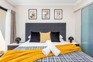 una camera da letto con un letto grande con asciugamani sopra di Stylish City 1bdrm Apt Perth Heart 2 mins river a Perth Altre 28 foto